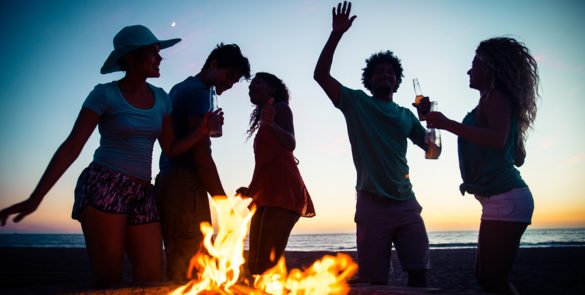 Multicultural group of friends partying on the beach - Young people celebrating during summer vacation summertime and holidays concepts